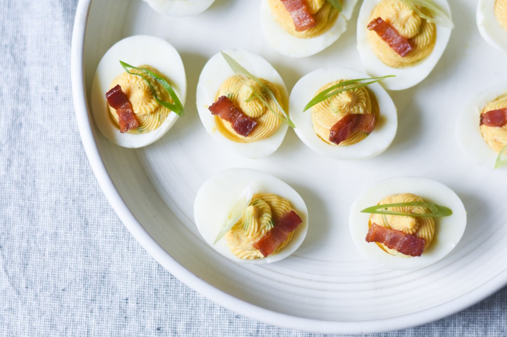 Bacon deviled eggs with bacon garnish and scallions, keto