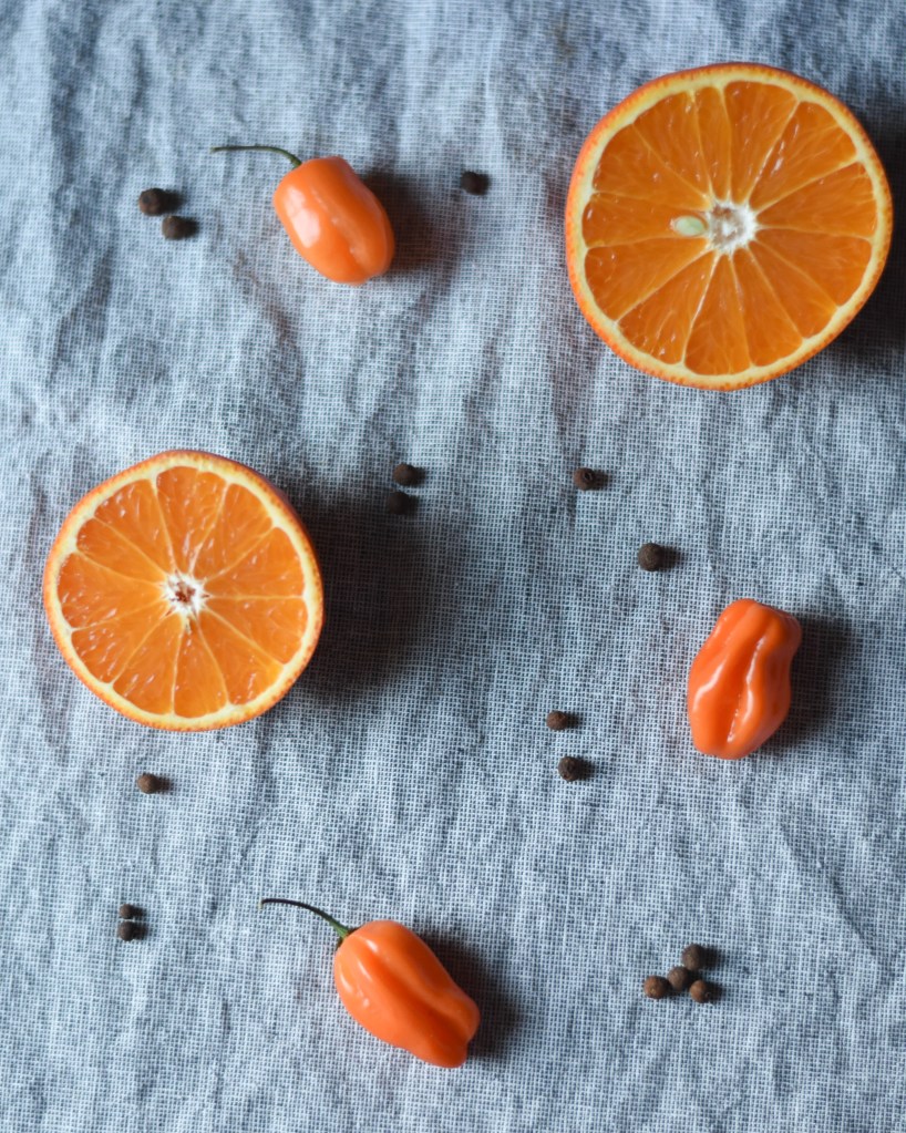 halved oranges, habanero, and allspice (pimento)